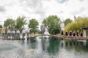 The bride and groom on a bridge with their attendants