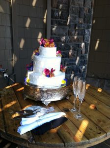 A white cake on a wooden table.