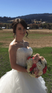 A bride in a wedding dress holding a bouquet.