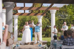 Newlyweds cheering after the ceremony