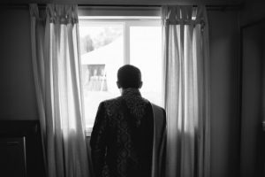 A man standing in front of a window.