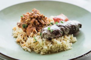 A plate with rice and meat on it.
