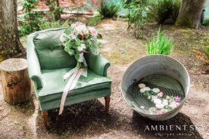 An armchair and bucket with flowers
