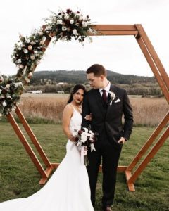 The bride holds her groom intimately