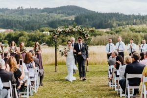 Newlyweds walking from the wedding arch