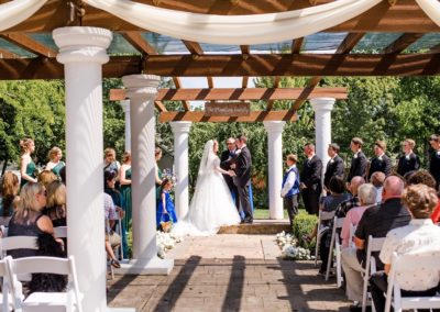 The bride and groom face each other during the ceremony