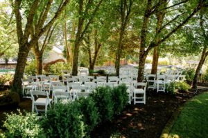 A wedding ceremony set up in a shady grove, providing design inspiration from the natural wooded area.