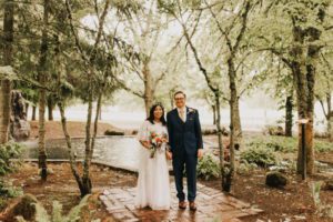 Bride and groom strolling under the trees