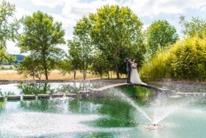 The newlyweds on a bridge near a fountain