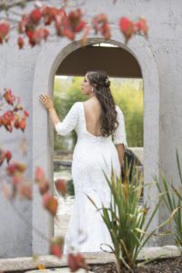 The bride standing at an archway