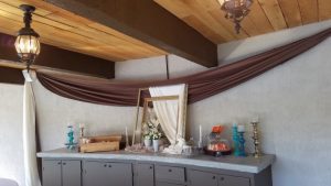 A buffet table with a curtain hanging over it.