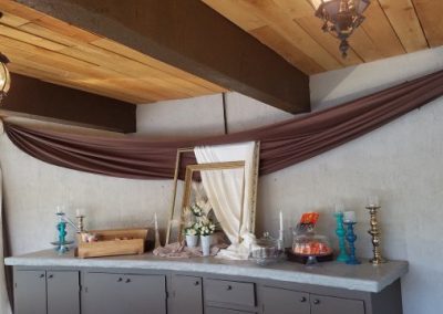 A buffet table with a curtain hanging over it.