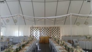A wedding reception set up in a tent.