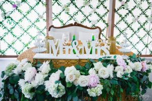A table with flowers and a mr and mrs sign.