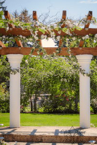 White pillars with flowers on them.
