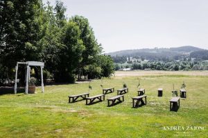 A wedding ceremony set up in the middle of a field.