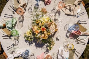 A round table set up with plates and silverware.