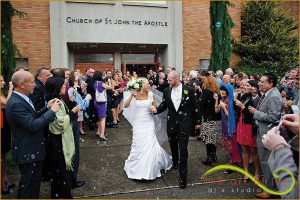 Confetti being thrown at the bride and groom.