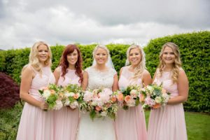 A bride and her bridesmaids holding bouquets