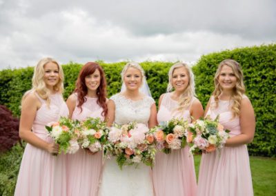 A bride and her bridesmaids holding bouquets