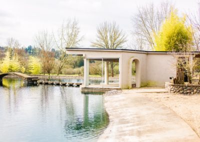 A small building at the edge of the pond