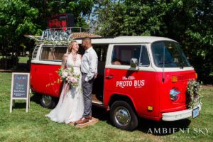 The newlyweds next to the Photo Bus