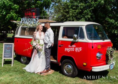 The newlyweds next to the Photo Bus