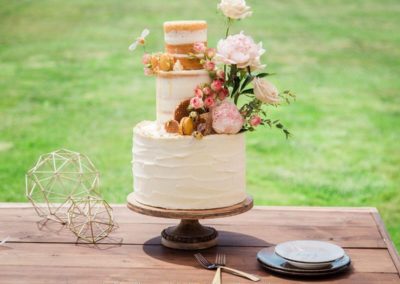 A tiered wedding cake with toppers