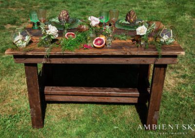 A table with herbs and sliced citrus