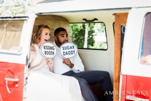 Newlyweds holding photo booth props