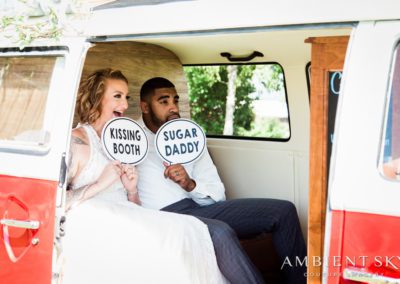 Newlyweds holding photo booth props