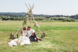 Newlyweds kissing on the grass
