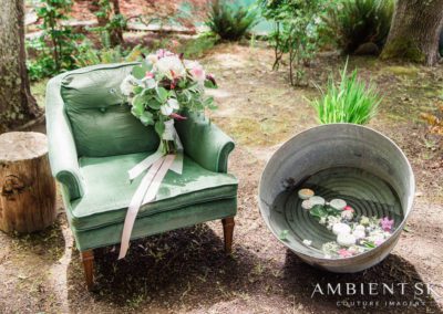 An armchair and bucket with flowers