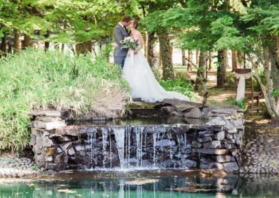 A bride and groom kissing from a distance