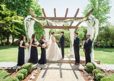 The newlyweds and their attendants near the altar