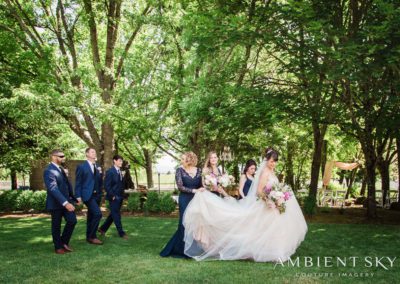 The groom following the bride and her attendants