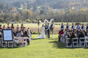 A breathtaking meadow wedding ceremony with mountains in the background.