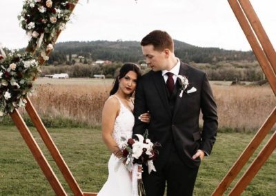 The bride holds her groom intimately