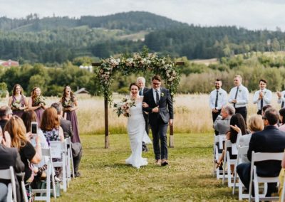 Newlyweds walking from the wedding arch