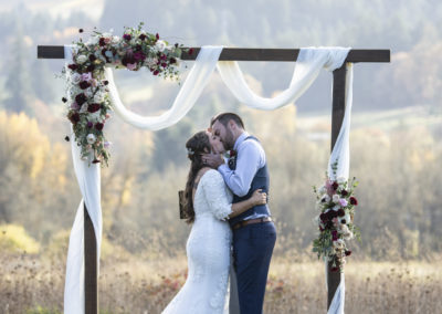 Newlyweds share a kiss at the arch