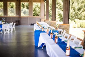 A table set up with blue and white tablecloths.