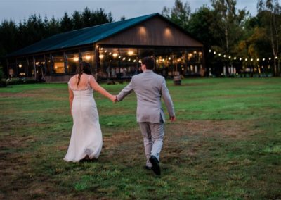 Bride and groom holding hands as they return to the party