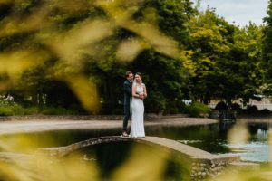 The newlyweds hugging at the bridge
