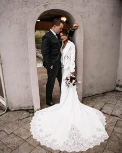 Bride standing next to her groom at an entrance