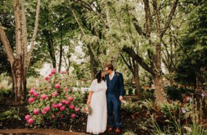 The newlyweds looking at each other in the garden
