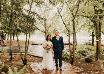 Bride and groom strolling under the trees