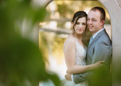 A bride and groom hold each other at the archway