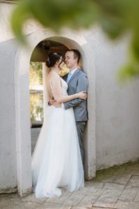 The bride and groom holding each other happily