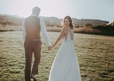 Newlyweds walking toward the sun