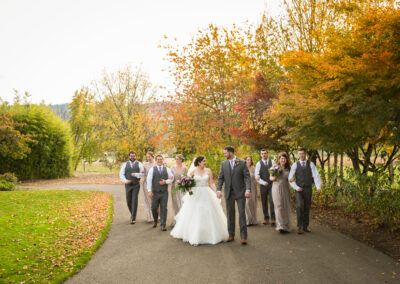 The newlyweds and their attendants walking down a path